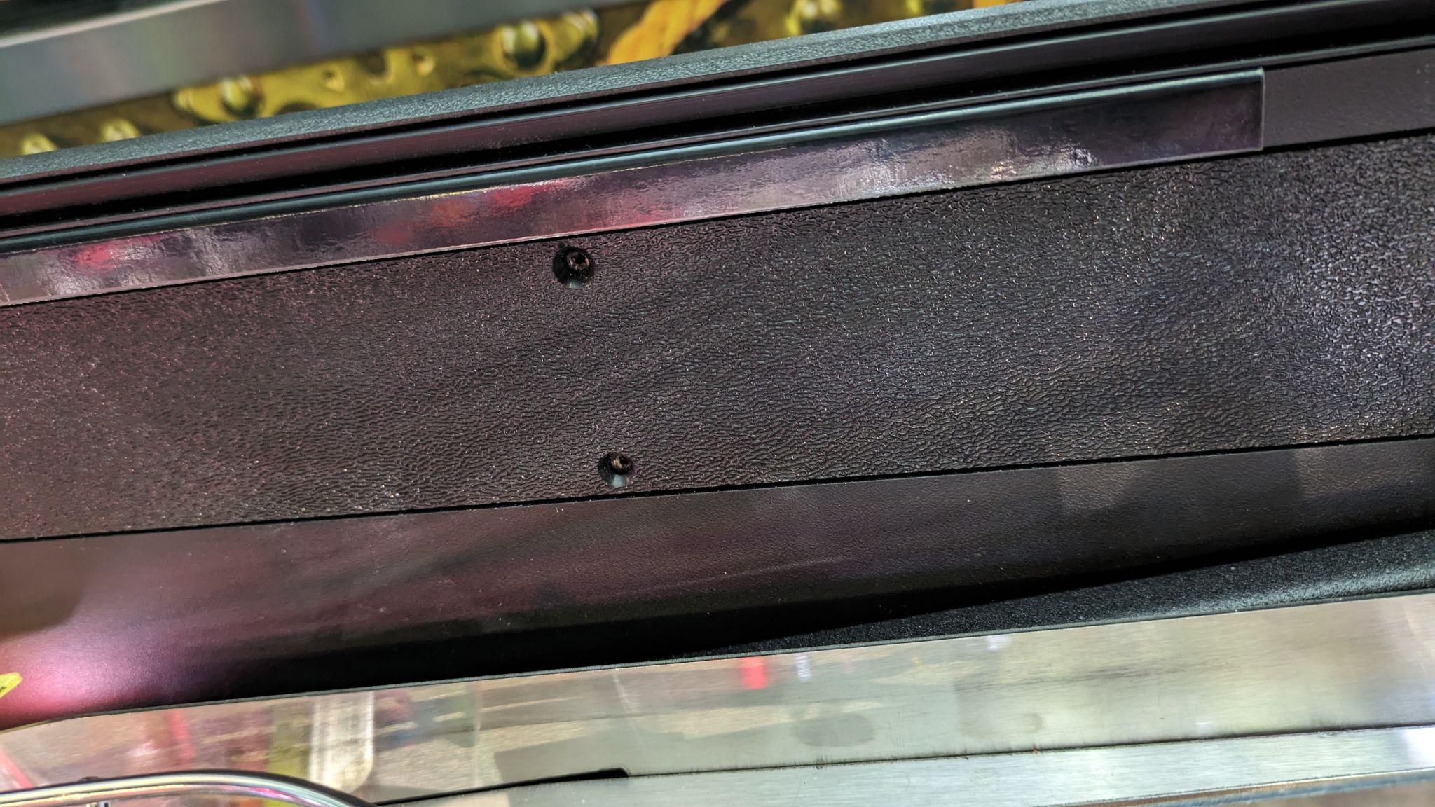 Pinlights metal cabinet mount installed inside a pinball cabinet between the wall and glass channel